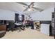 Home office with neutral carpet, two desks, computer monitors, storage, and a freezer at 12425 Bellaire Dr, Thornton, CO 80241