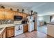 Efficient kitchen features wooden cabinets and modern appliances at 12425 Bellaire Dr, Thornton, CO 80241