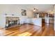 Bright living room featuring a brick fireplace, hardwood floors and a ceiling fan at 12425 Bellaire Dr, Thornton, CO 80241
