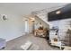 Comfortable living area featuring carpeted floors, and an accent wall at 12425 Bellaire Dr, Thornton, CO 80241