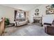 Cozy living room features a brick fireplace, large windows, and comfortable seating at 12425 Bellaire Dr, Thornton, CO 80241