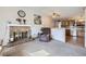 Inviting living room features a fireplace, cozy armchair and natural light at 12425 Bellaire Dr, Thornton, CO 80241
