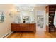 Bathroom featuring double sinks, a large mirror, and views into the bedroom at 1952 Columbine Ct, Golden, CO 80401