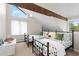 Bright bedroom with two beds, vaulted ceiling with beam, and lots of natural light at 1952 Columbine Ct, Golden, CO 80401