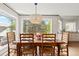 Bright dining room with wooden table, chairs, and natural light from surrounding windows at 1952 Columbine Ct, Golden, CO 80401