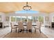Charming dining room featuring a wooden ceiling, large windows, and comfortable cushioned seating at 1952 Columbine Ct, Golden, CO 80401