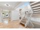 Inviting entryway with tiled flooring, white stairs, storage closet, and a window bench at 1952 Columbine Ct, Golden, CO 80401