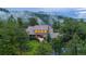 Secluded two-story home enveloped by lush trees and rolling hills with misty mountain views at 1952 Columbine Ct, Golden, CO 80401