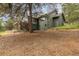 Exterior of a multi-level gray house surrounded by a natural landscape and a deck with stairs at 1952 Columbine Ct, Golden, CO 80401