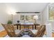 Well-lit office with a dark wood desk, decorative rug, and a large window showcasing a nature view at 1952 Columbine Ct, Golden, CO 80401