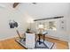 Well-lit office with a dark wood desk, decorative rug, and a large window showcasing a nature view at 1952 Columbine Ct, Golden, CO 80401