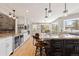 Open kitchen with island, granite countertops, and bar seating at 1952 Columbine Ct, Golden, CO 80401