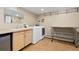 Bright laundry room featuring a new washer and dryer, utility sink, and convenient shelving at 1952 Columbine Ct, Golden, CO 80401