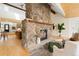Comfortable living room with a striking stone fireplace, and hardwood floors, offering easy access to stairs at 1952 Columbine Ct, Golden, CO 80401