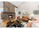 Cozy living room with a stone fireplace, hardwood floors, and comfortable seating arrangements at 1952 Columbine Ct, Golden, CO 80401
