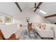 Spacious living area with vaulted ceiling, wooden beams, and a cozy seating arrangement at 1952 Columbine Ct, Golden, CO 80401