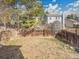 Fenced backyard with sparse grass and some trees at 8047 Lee Ct, Arvada, CO 80005