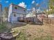 Backyard showcasing two story home, wood fence, and patio at 8047 Lee Ct, Arvada, CO 80005