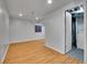 Finished basement area with wood-look floors and a utility room at 8047 Lee Ct, Arvada, CO 80005