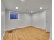 Finished basement space featuring wood-look flooring, neutral paint, and recessed lights at 8047 Lee Ct, Arvada, CO 80005