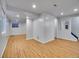 Spacious finished basement with wood-look floors, neutral walls, and recessed lighting at 8047 Lee Ct, Arvada, CO 80005
