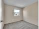 Neutral bedroom featuring soft gray carpet and a bright window at 8047 Lee Ct, Arvada, CO 80005