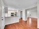Bright, open kitchen with white cabinets, stainless steel appliances, and hardwood floors at 8047 Lee Ct, Arvada, CO 80005