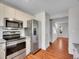 Modern kitchen with stainless steel appliances, bright lighting, and an open layout at 8047 Lee Ct, Arvada, CO 80005