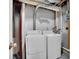 Laundry room with white washer and dryer units and visible piping at 8047 Lee Ct, Arvada, CO 80005
