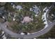 Aerial view of home on a wooded lot with circular driveway at 2828 Keystone Dr, Evergreen, CO 80439