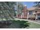 A home's backyard featuring a brick chimney, deck, and lush greenery creates a serene outdoor living space at 2828 Keystone Dr, Evergreen, CO 80439