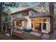 Exterior view of back of house with outdoor deck and patio furniture with lush green trees surrounding the yard at 2828 Keystone Dr, Evergreen, CO 80439