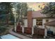 Backyard view of deck and wooded perimeter provides a private outdoor retreat on this property at 2828 Keystone Dr, Evergreen, CO 80439