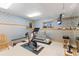 Basement workout room featuring a treadmill, stationary bike and custom wallpaper at 2828 Keystone Dr, Evergreen, CO 80439