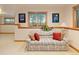 Comfortable finished basement area with sofa, natural light, and wood trim at 2828 Keystone Dr, Evergreen, CO 80439