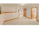 Spacious finished basement area with neutral carpeting and access to a bathroom at 2828 Keystone Dr, Evergreen, CO 80439