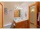 Bathroom featuring wood cabinets, a sink, and decorative towels and natural lighting at 2828 Keystone Dr, Evergreen, CO 80439