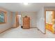 Bright bedroom with a view from the window and a bathroom door at 2828 Keystone Dr, Evergreen, CO 80439