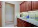 Functional butler's pantry with granite countertops and cherry wood cabinets at 2828 Keystone Dr, Evergreen, CO 80439