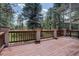 Large outdoor deck with wood railings and posts offering an inviting space for entertaining at 2828 Keystone Dr, Evergreen, CO 80439