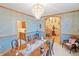 Elegant dining room with a chandelier, wood trim, and a formal table setting, ideal for entertaining guests at 2828 Keystone Dr, Evergreen, CO 80439