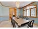 Bright dining room with ample seating and natural light from the large window at 2828 Keystone Dr, Evergreen, CO 80439