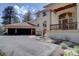 Detailed view of the stucco exterior, tile roof, and attached garage at 2828 Keystone Dr, Evergreen, CO 80439