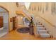 Grand foyer with hardwood floors, curved staircase, elegant chandelier, and unique decorative elements at 2828 Keystone Dr, Evergreen, CO 80439
