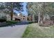 Inviting two-story home with a long driveway and beautiful mature trees at 2828 Keystone Dr, Evergreen, CO 80439