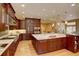 Open kitchen design includes an island with seating, stainless appliances, and ample counter space at 2828 Keystone Dr, Evergreen, CO 80439