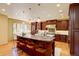 Gourmet kitchen with a large center island, dark wood cabinetry, and pendant lighting at 2828 Keystone Dr, Evergreen, CO 80439