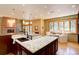 Bright and open kitchen showcases a large island, granite countertops, and a breakfast nook at 2828 Keystone Dr, Evergreen, CO 80439