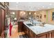 This kitchen has a kitchen island, stainless steel appliances, lots of cabinets, and hardwood floors at 2828 Keystone Dr, Evergreen, CO 80439