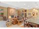 Inviting living room with a cozy fireplace, comfortable seating, and abundant natural light streaming through large windows at 2828 Keystone Dr, Evergreen, CO 80439
